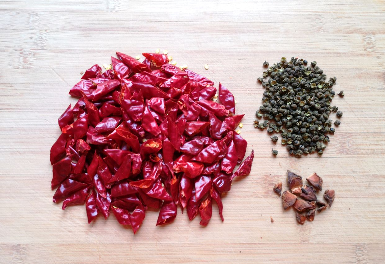 Prepare dried red chilies, star anise, and Sichuan peppercorns for cooking.