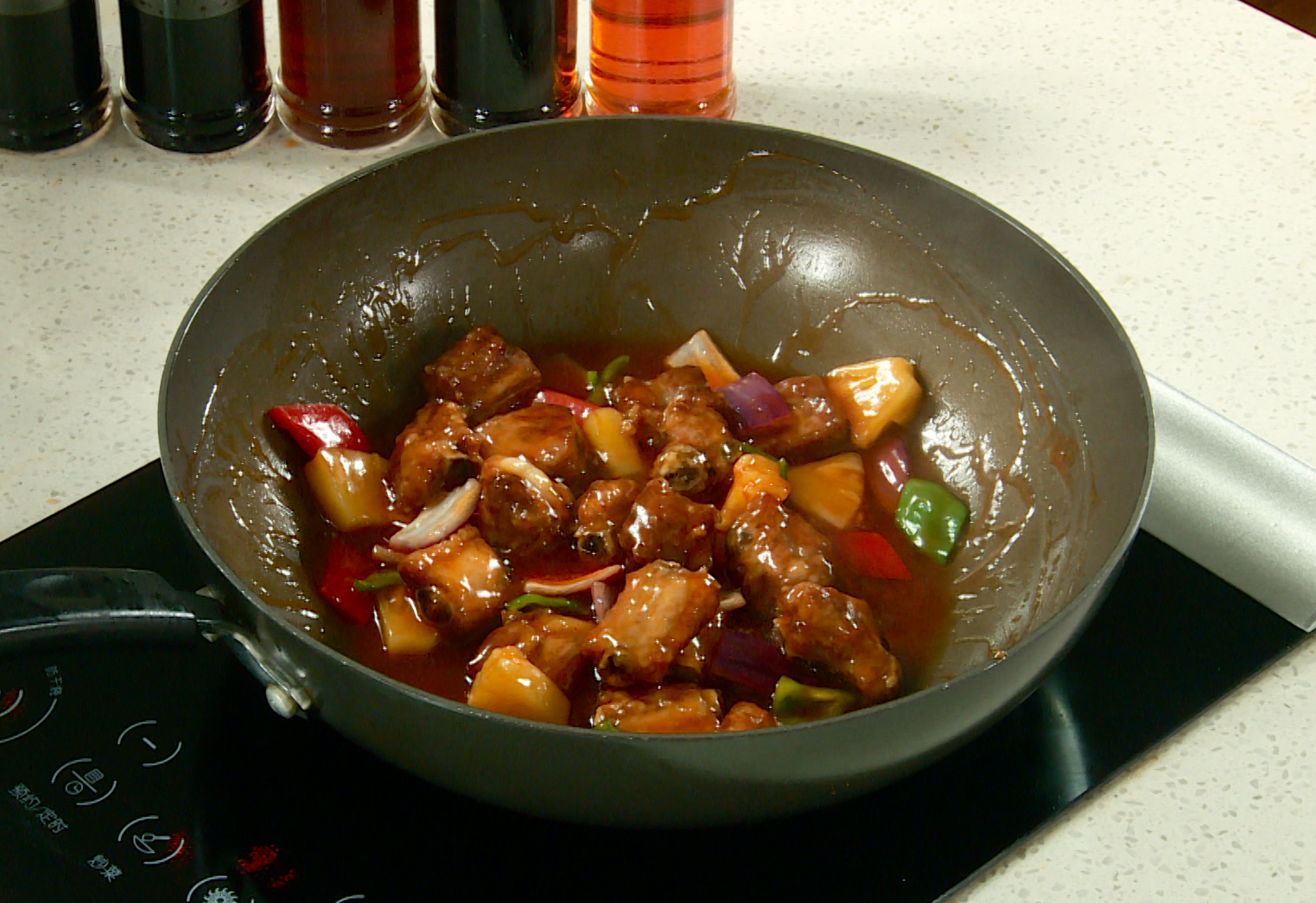 Combine fried ribs, bell peppers, onion in wok. Toss until coated with sauce.