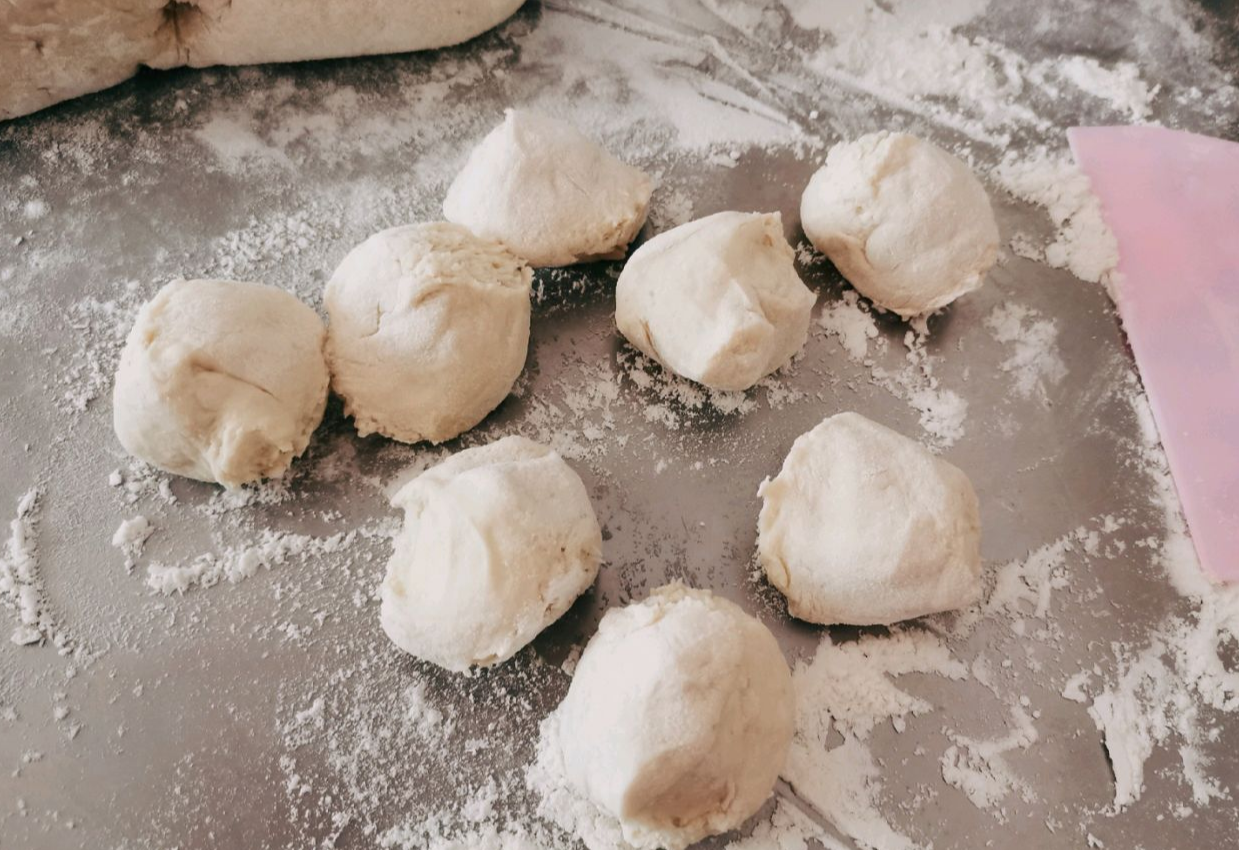 After rising, knead dough until smooth, release air bubbles, divide portions.