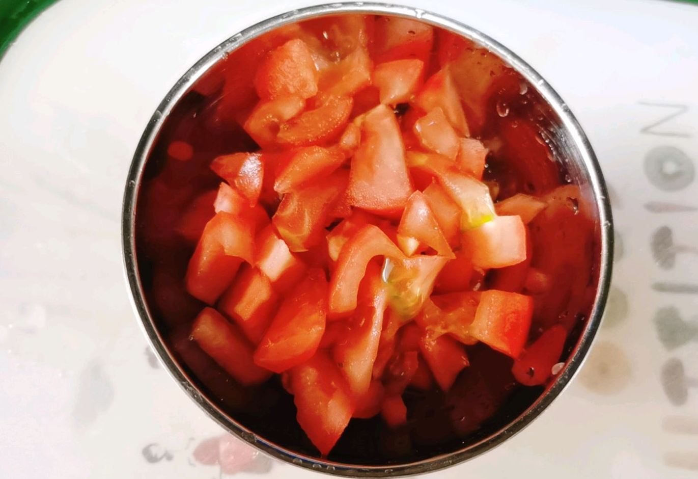 Prepare the tomato by washing, peeling, and cutting into small pieces.