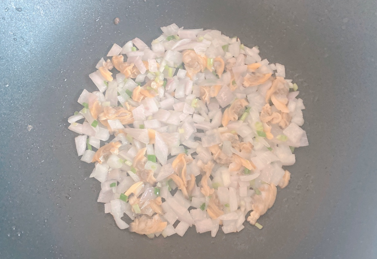 Spread minced onions in pan, reduce heat to medium-low.