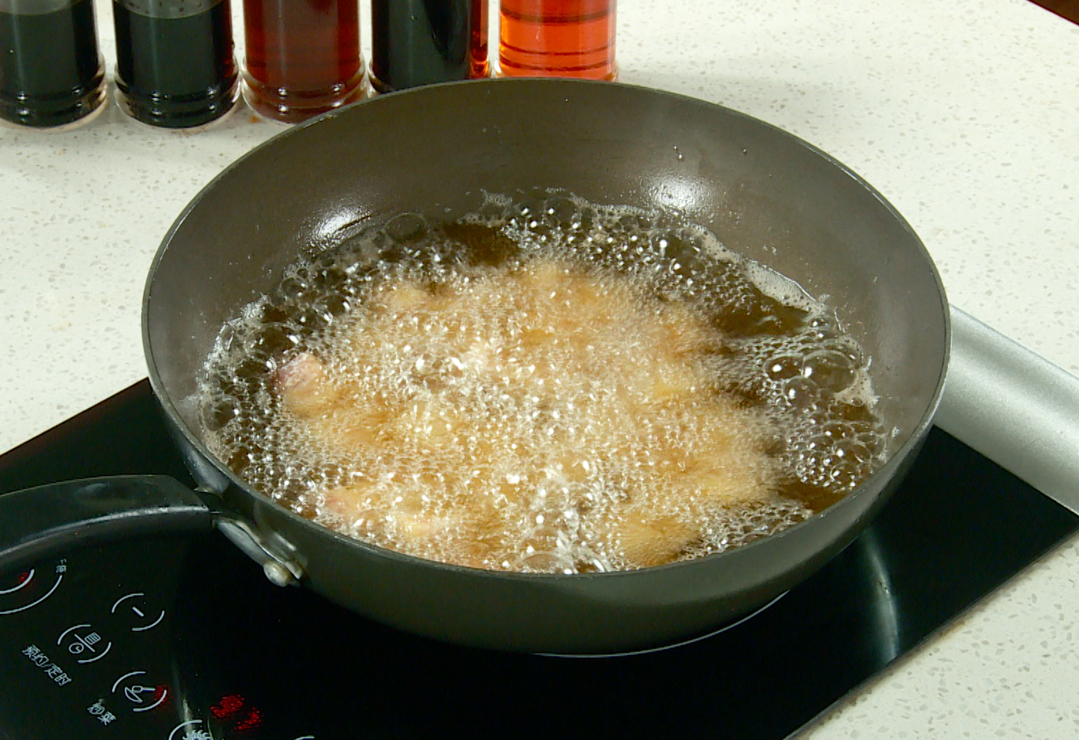 Fry pork cubes in hot oil until crispy and tender, then drain.