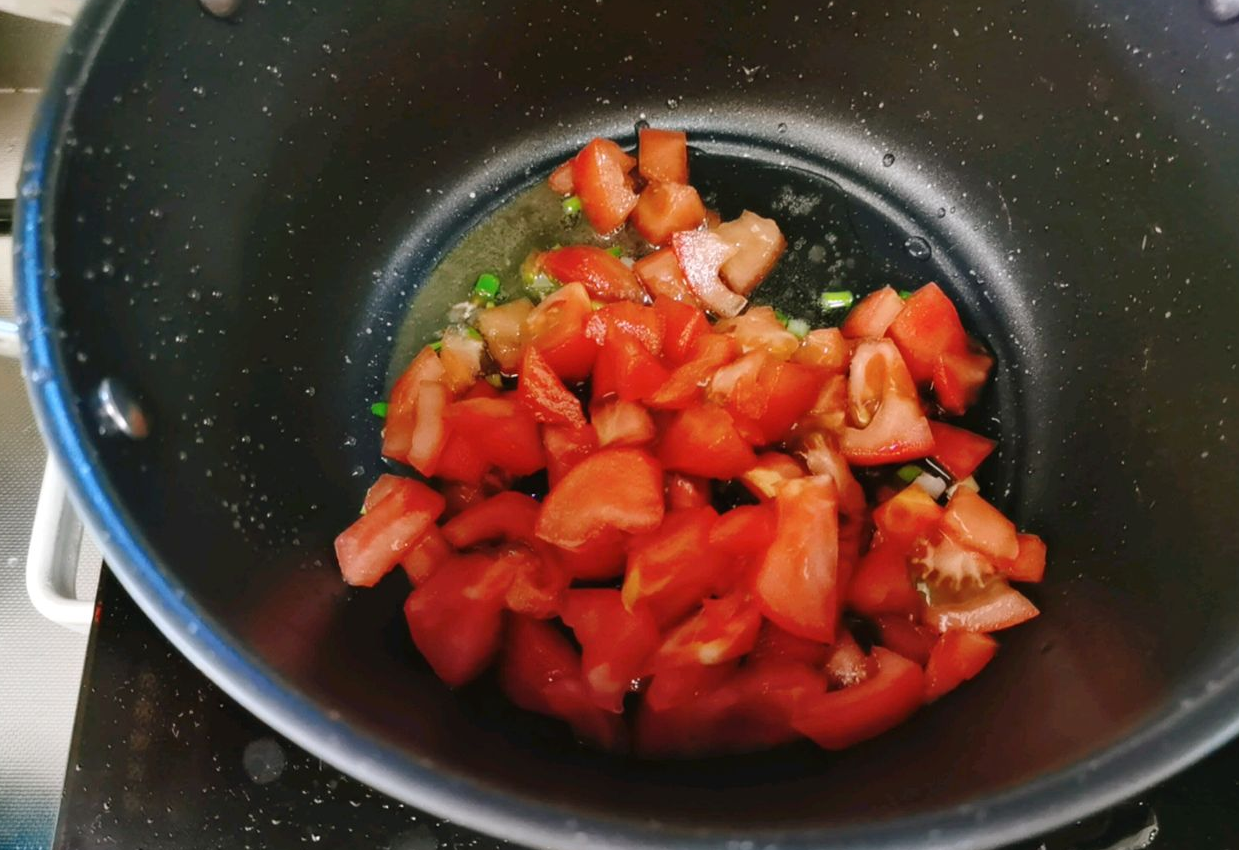 Stir-fry tomatoes until they release juices.