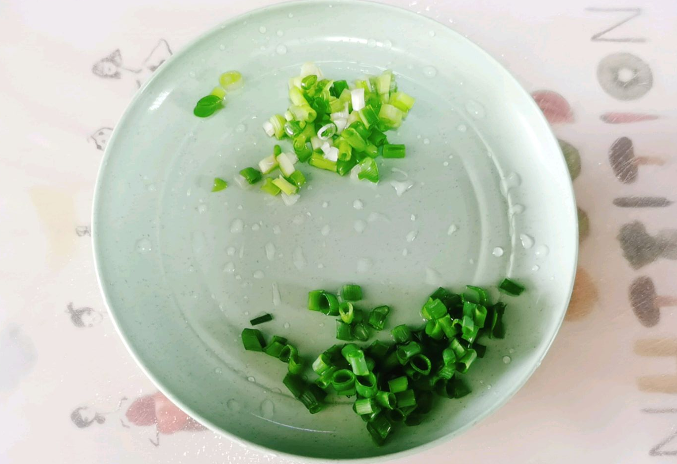 Wash and chop green onion, separating white and green parts.