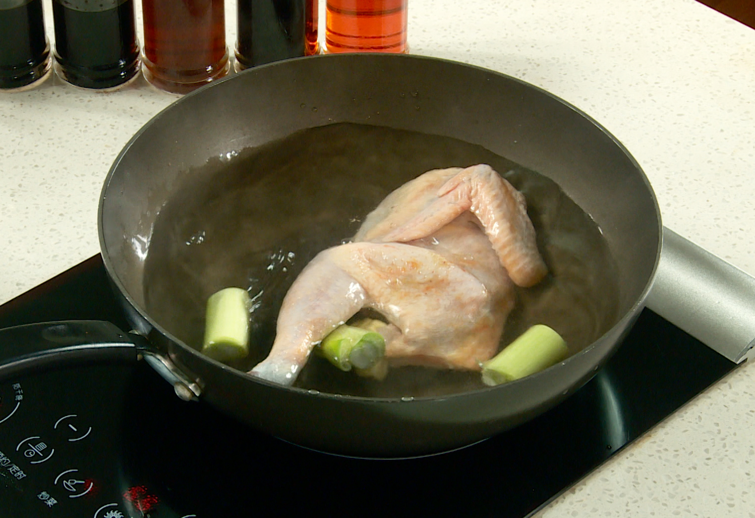 Boil chicken: Simmer chicken with scallions and ginger, then cool and cut into pieces.