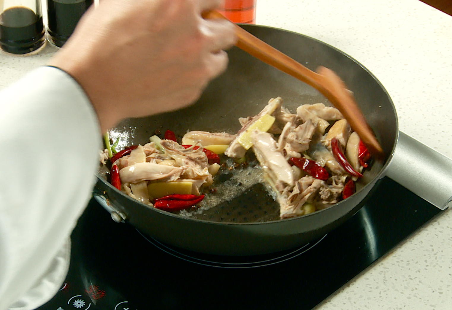 Simmer chicken in salted water until fully cooked.