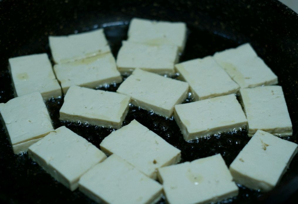 Shake pan gently to evenly heat tofu while cooking.