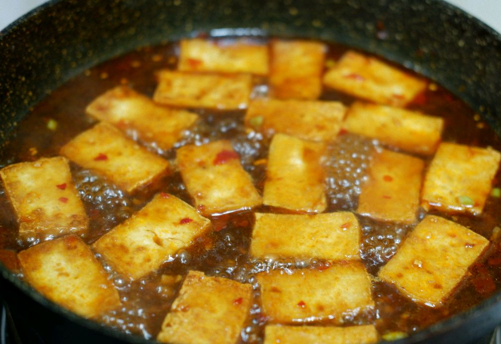 Boil mixture then simmer tofu for 4 mins over medium heat.