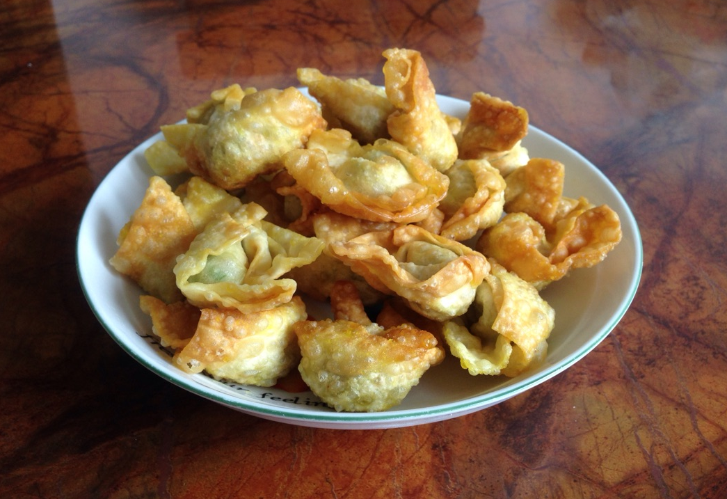 Fry wontons until golden brown and crispy.