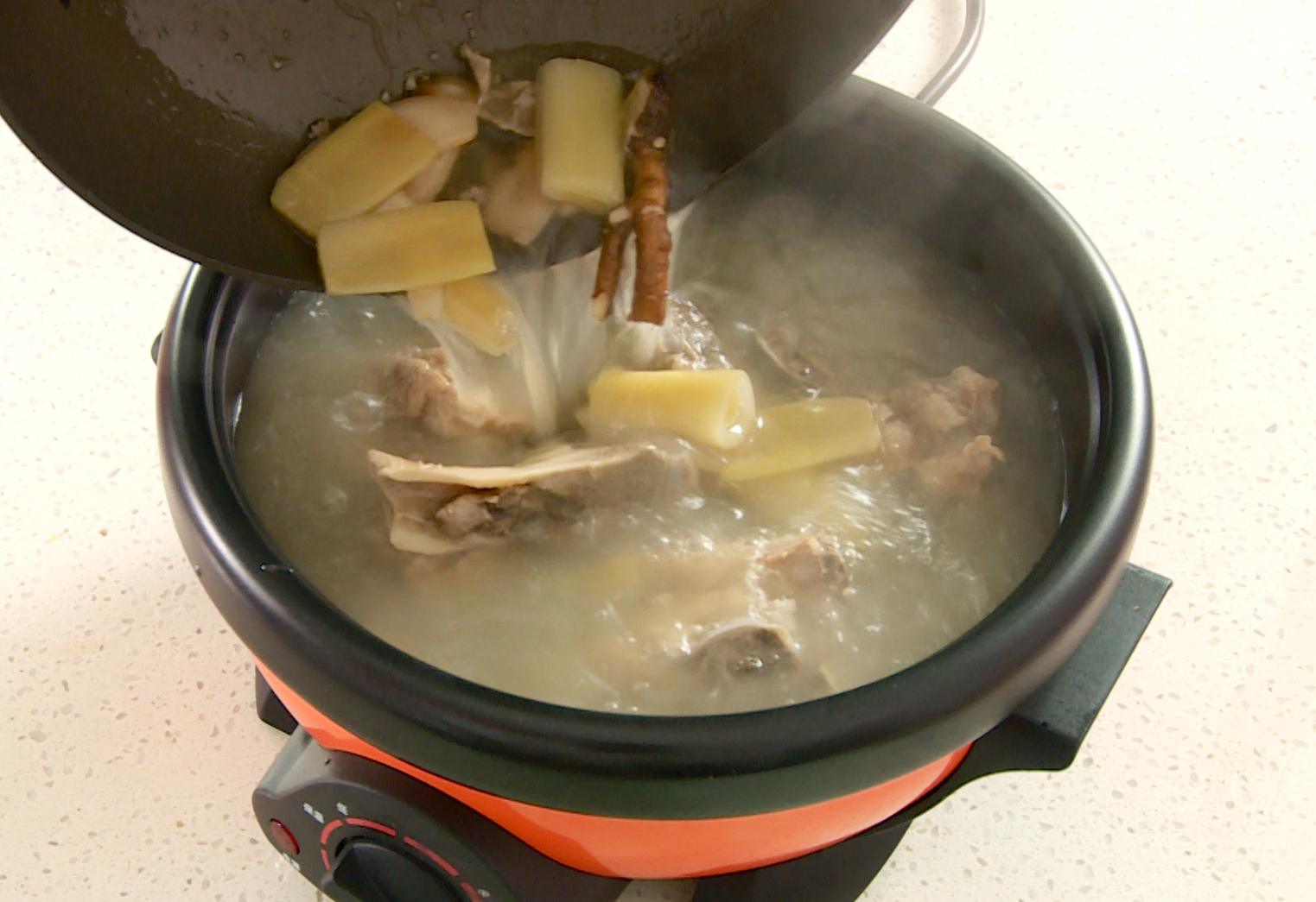 Season broth with salt after skimming foam, prepare for hot pot.