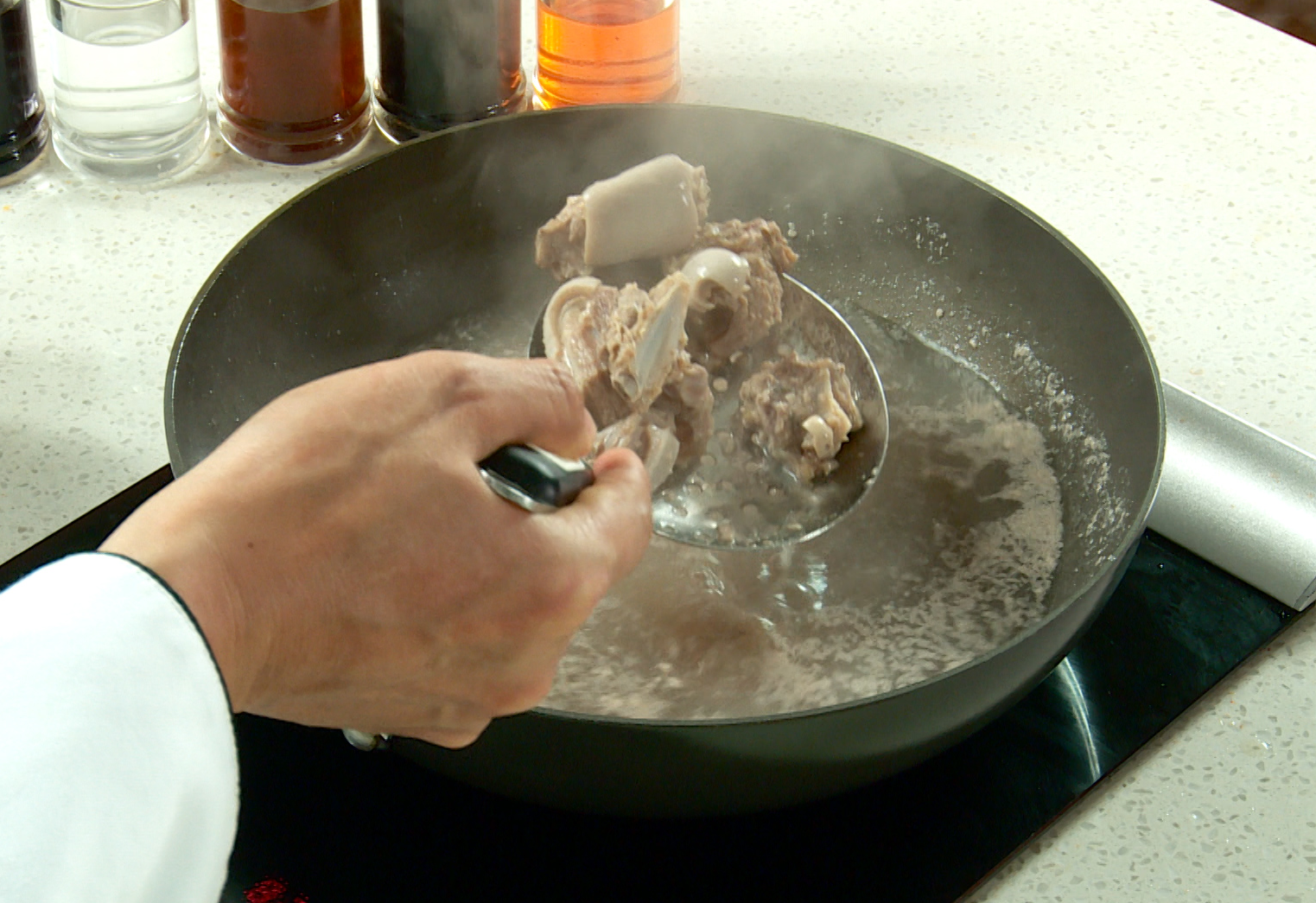 Blanch lamb ribs in water with white or alternative wine to enhance flavor.