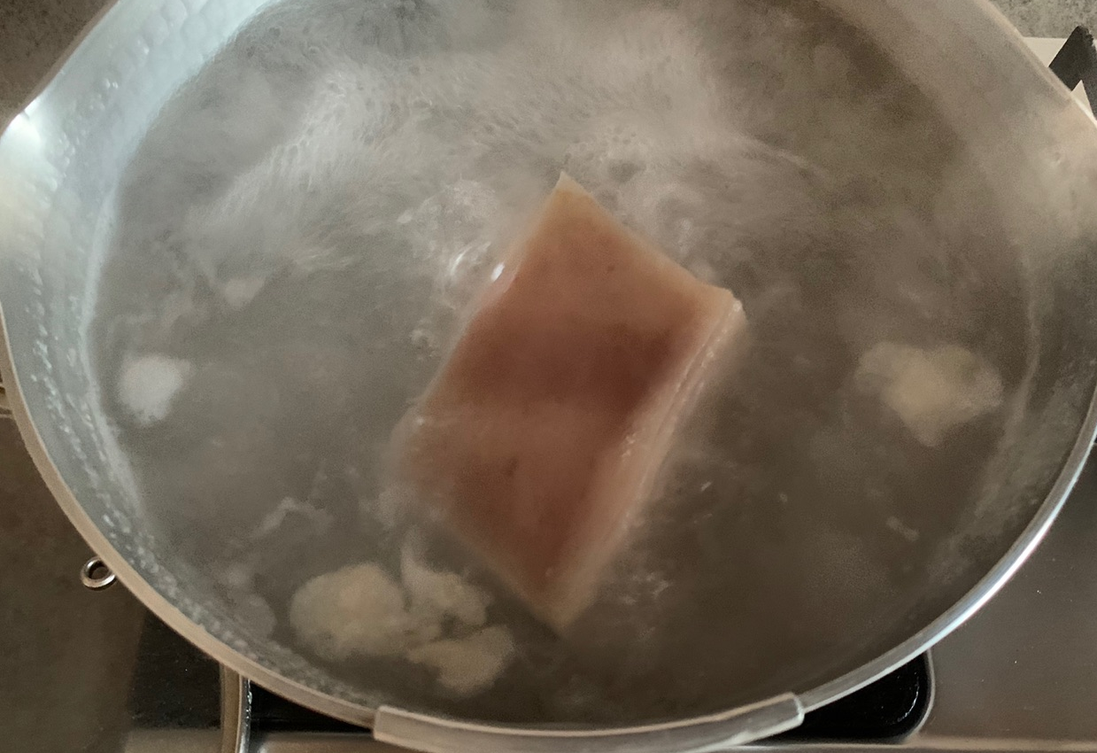 Boil pork belly in cold water until tender with a chopstick test.