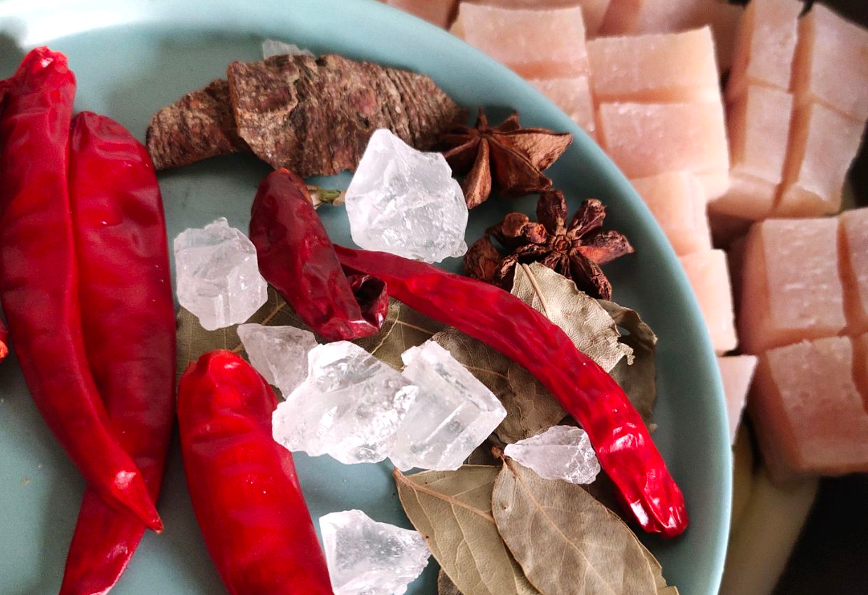 Add whole spices (star anise, cinnamon, bay leaves), dried chilies, rock sugar to pot.