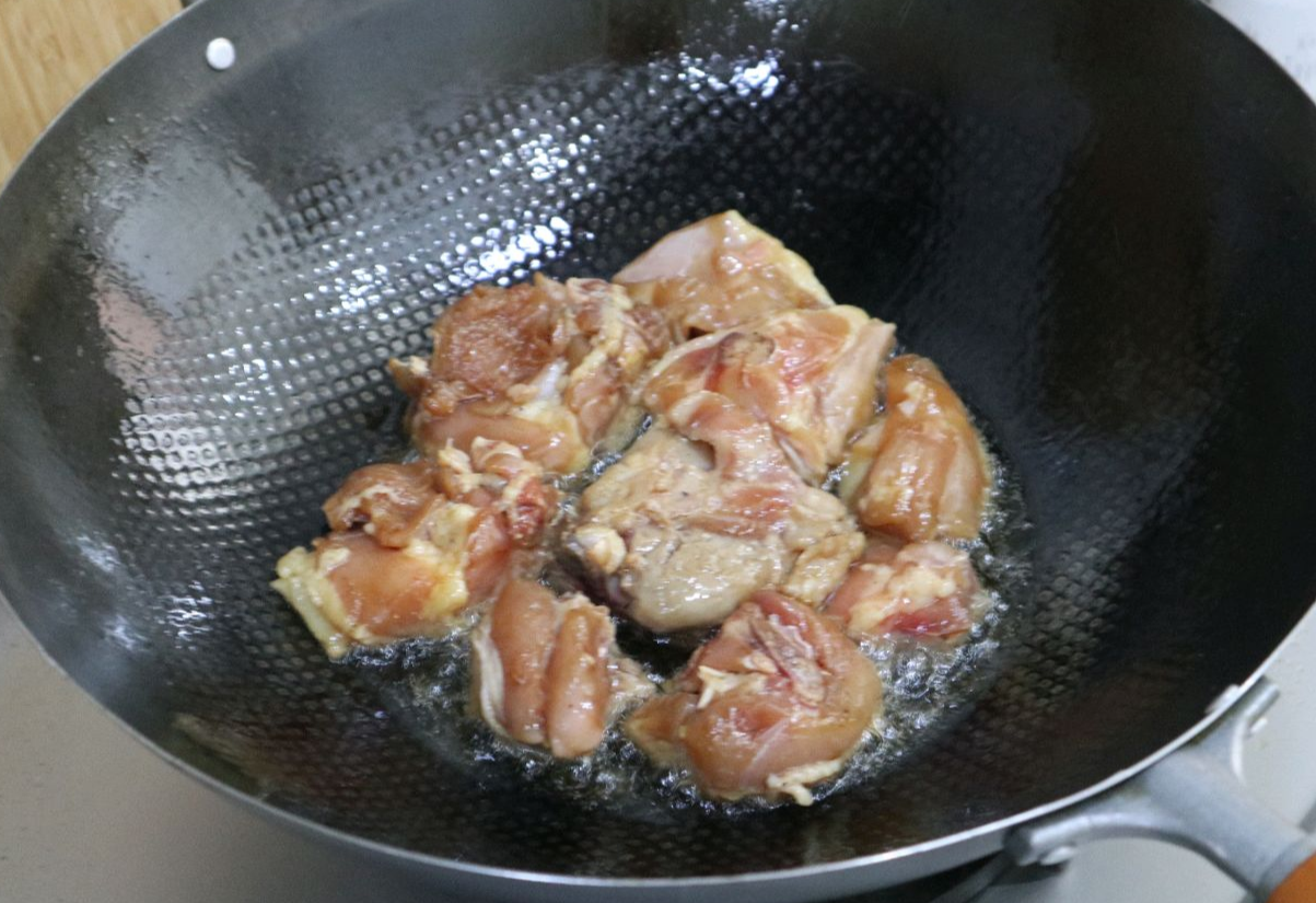 Add marinated chicken pieces to the pot.