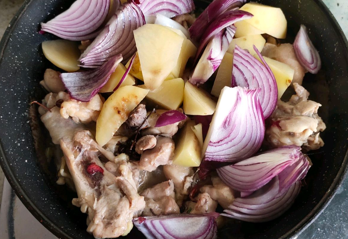 Add potato chunks and sliced onions to the recipe.