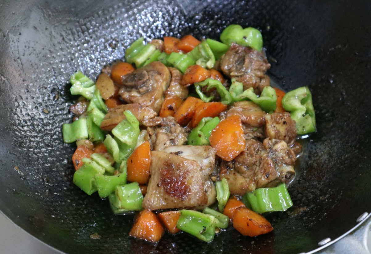 Add green peppers after simmering, stir-fry until cooked.