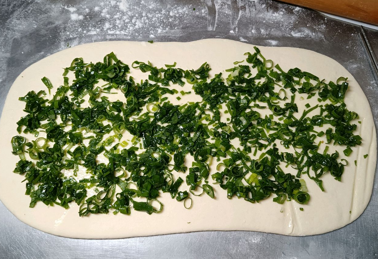 Spread scallion filling on dough evenly.