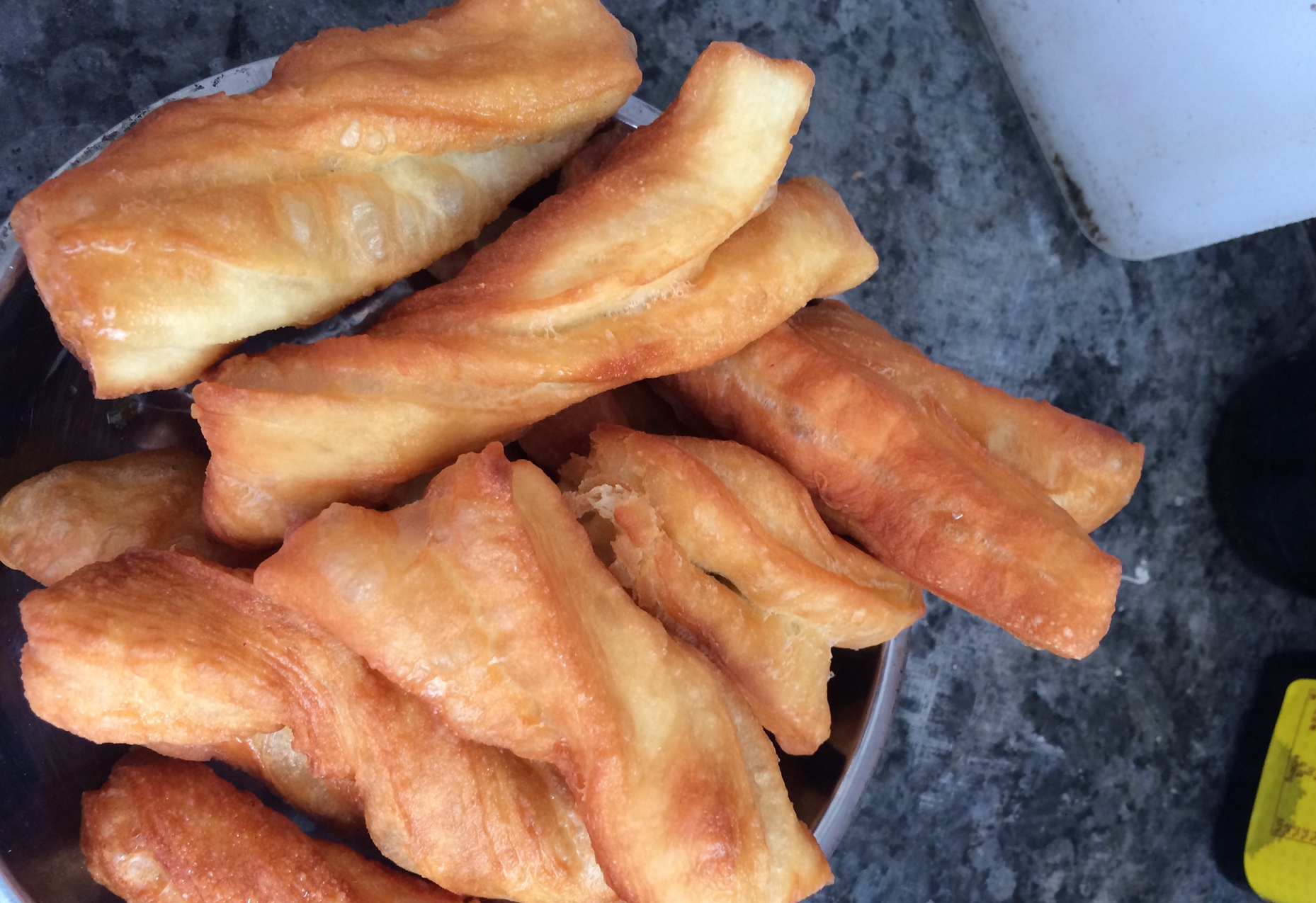 Use chopsticks to turn fritters for even heating, remove when golden brown, repeat frying process.