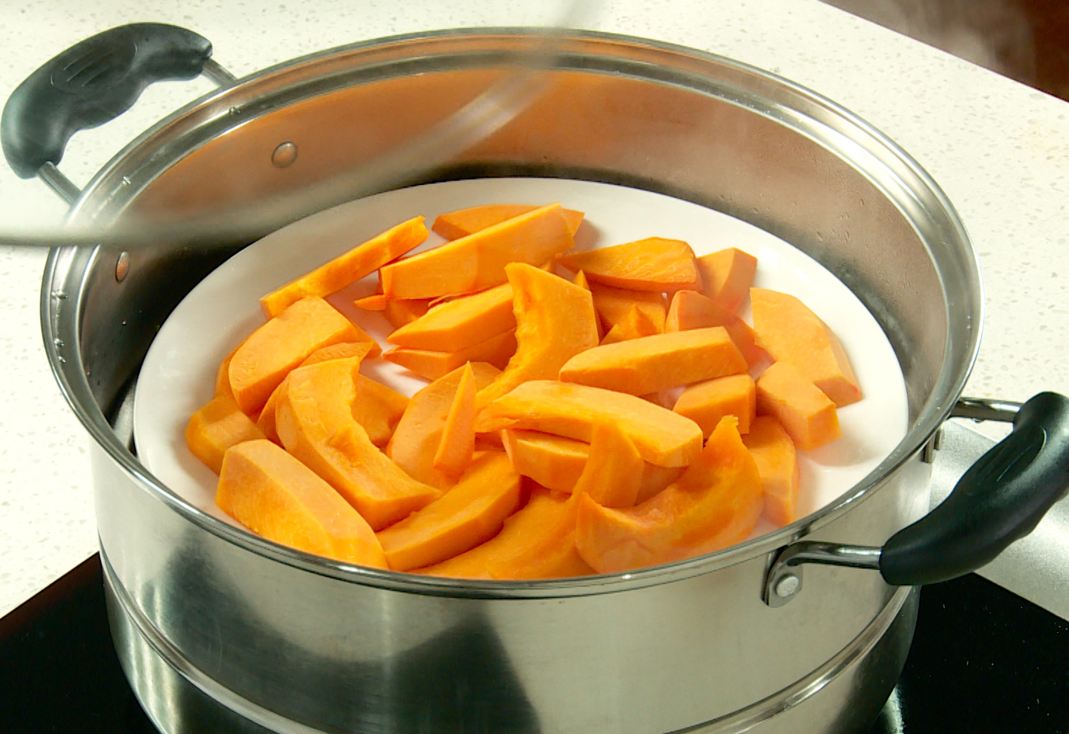 Steam pumpkin slices for 10 minutes, then remove from steamer.