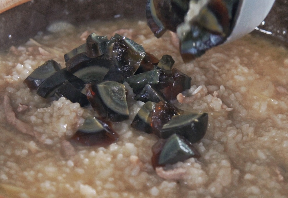 Cook rice until soft, add century eggs, oyster sauce, chicken bouillon, and salt; stir well. Cook for 5 mins.