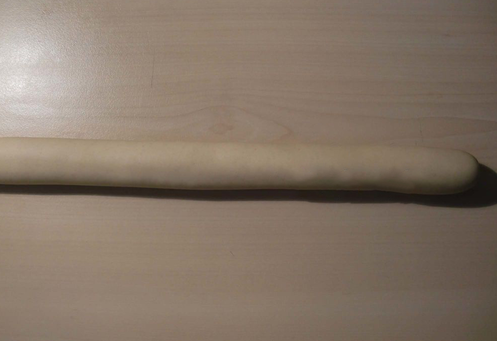 Roll rested dough into long strip.