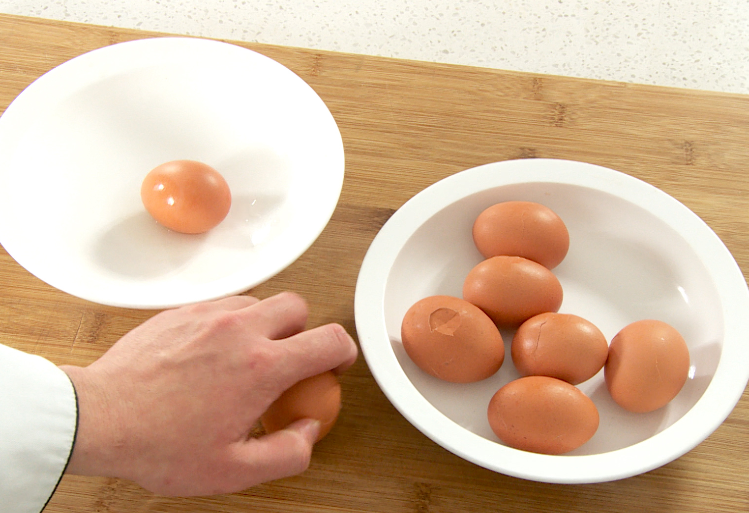 Crack eggshells after boiling, but keep them on the eggs.