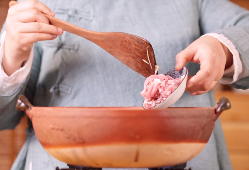 Stir-fry pork strips until color changes.