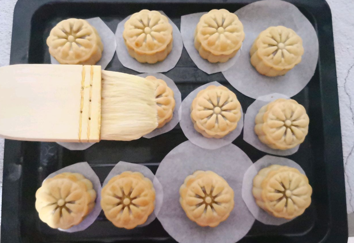 Brush mooncakes with egg wash, bake, cool, and store for better flavor.