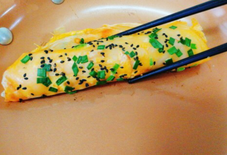 Roll up egg pancake using chopsticks for serving.