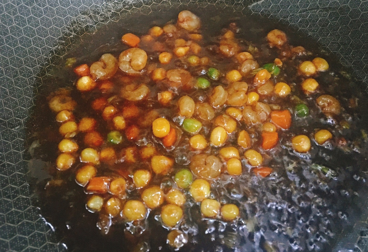 Simmer prepared sauce in pan until slightly thickened on low-medium heat; avoid burning.