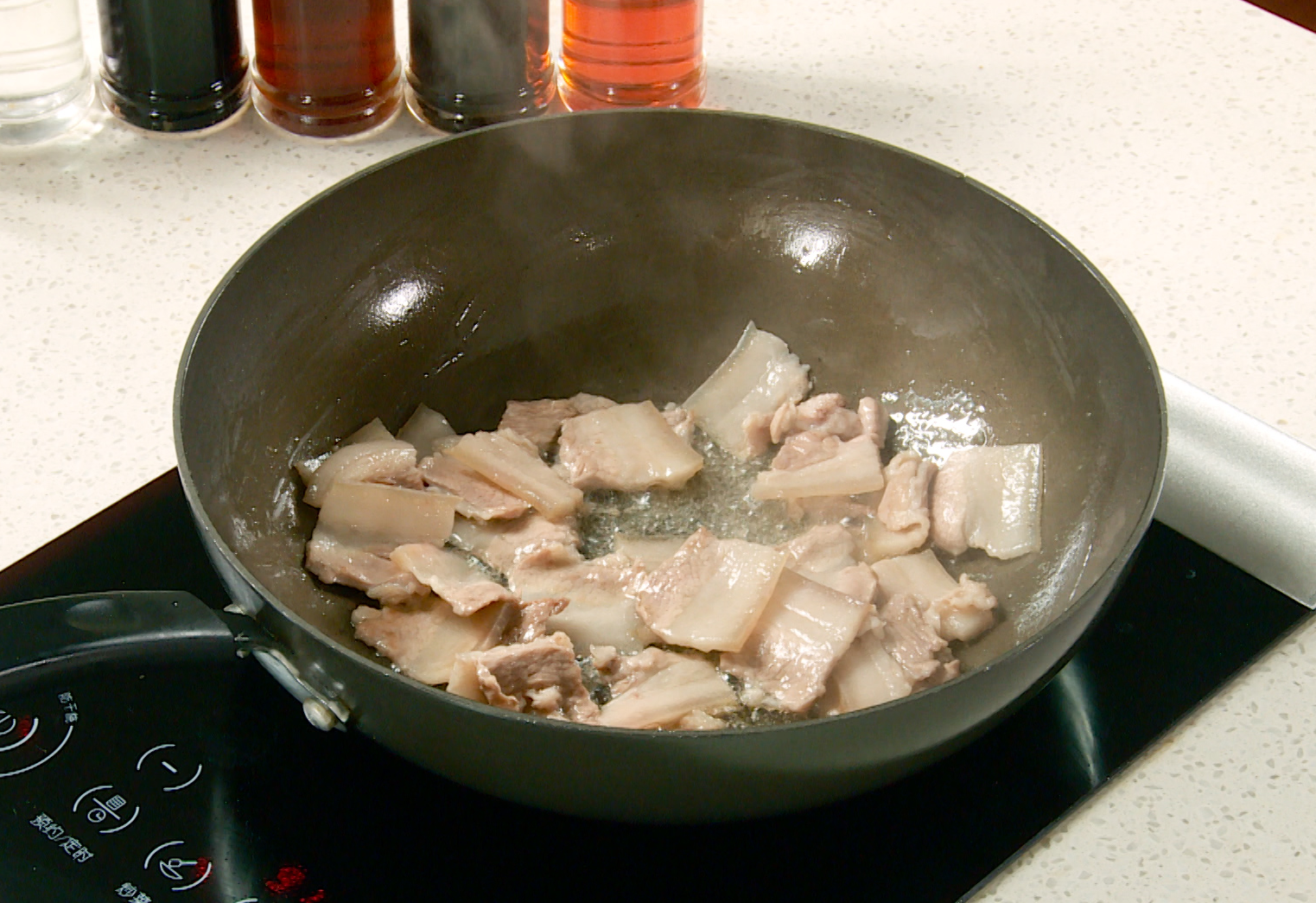 Cook sliced pork belly until golden, then remove excess oil for veggies.