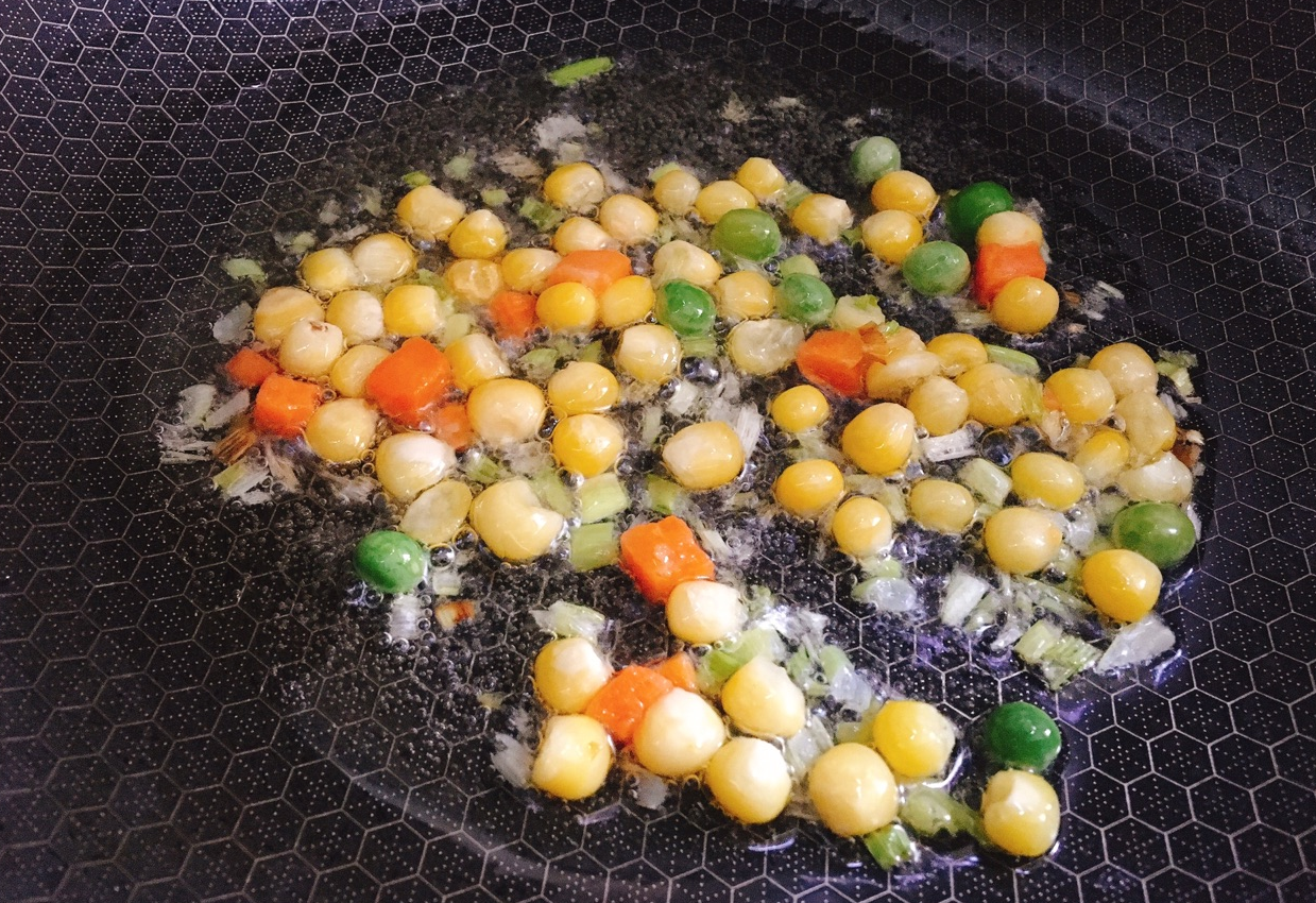 Add peas and corn to pan, stir-fry.