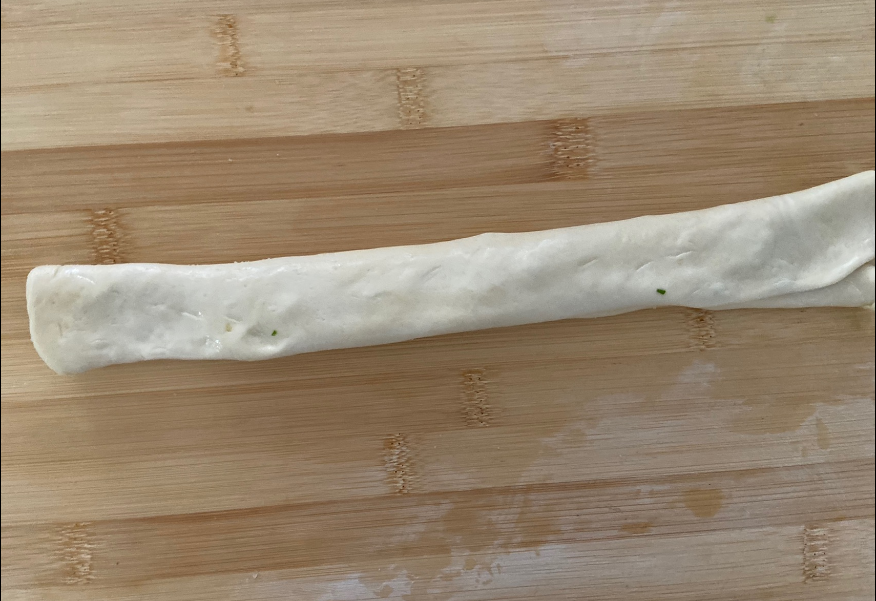 Stretch dough slowly lengthwise with hands.