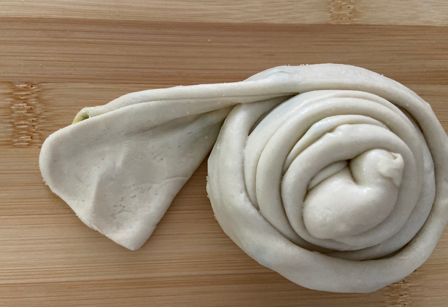 Roll up dough portions, tucking final end underneath. Repeat with remaining portions.