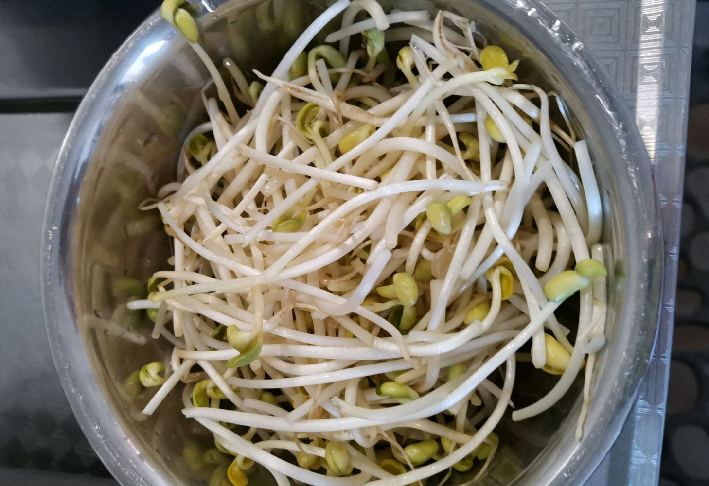 Wash and prepare 200g of soybean sprouts thoroughly, trimming roots before rinsing.