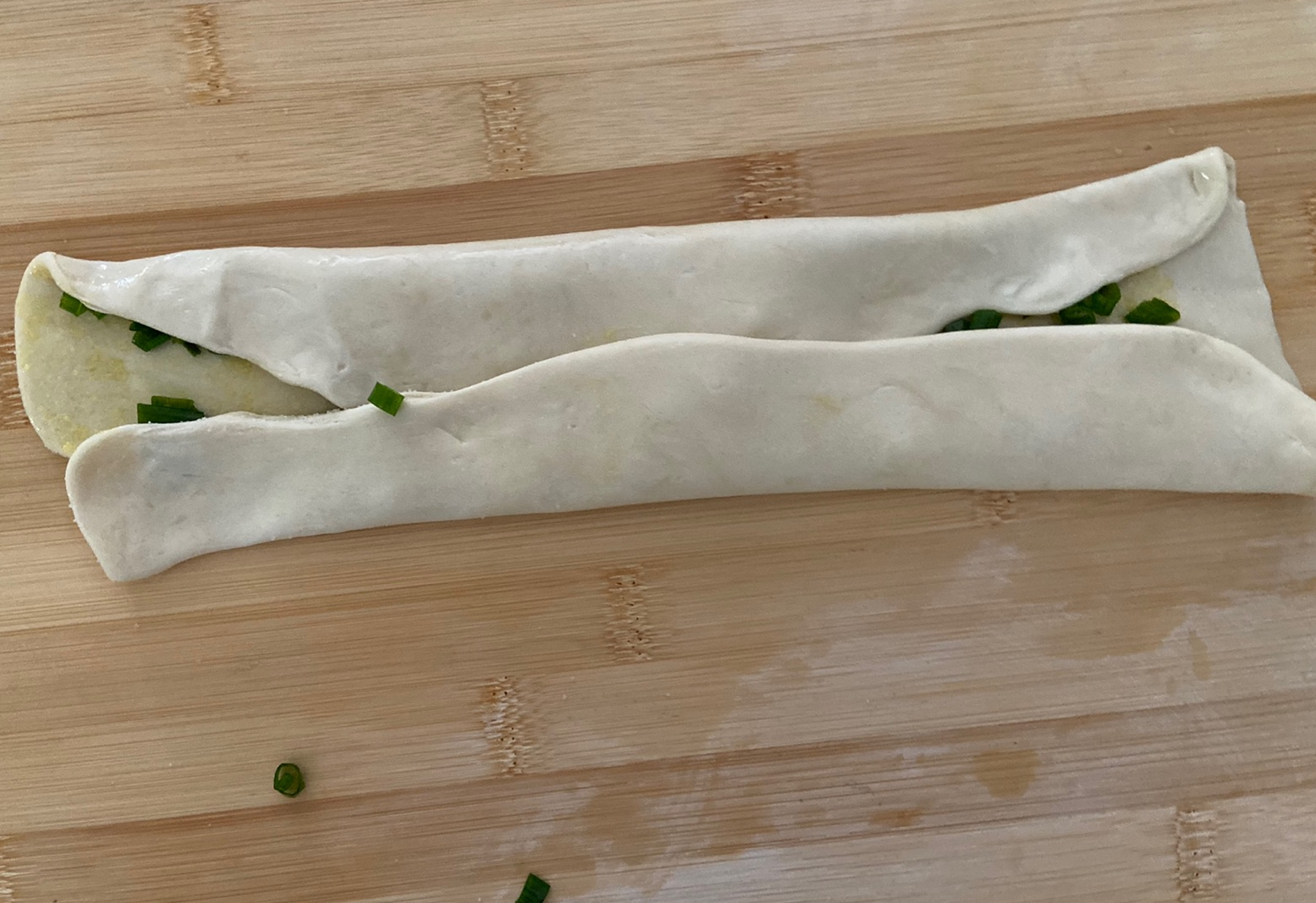 Fold dough in half twice.