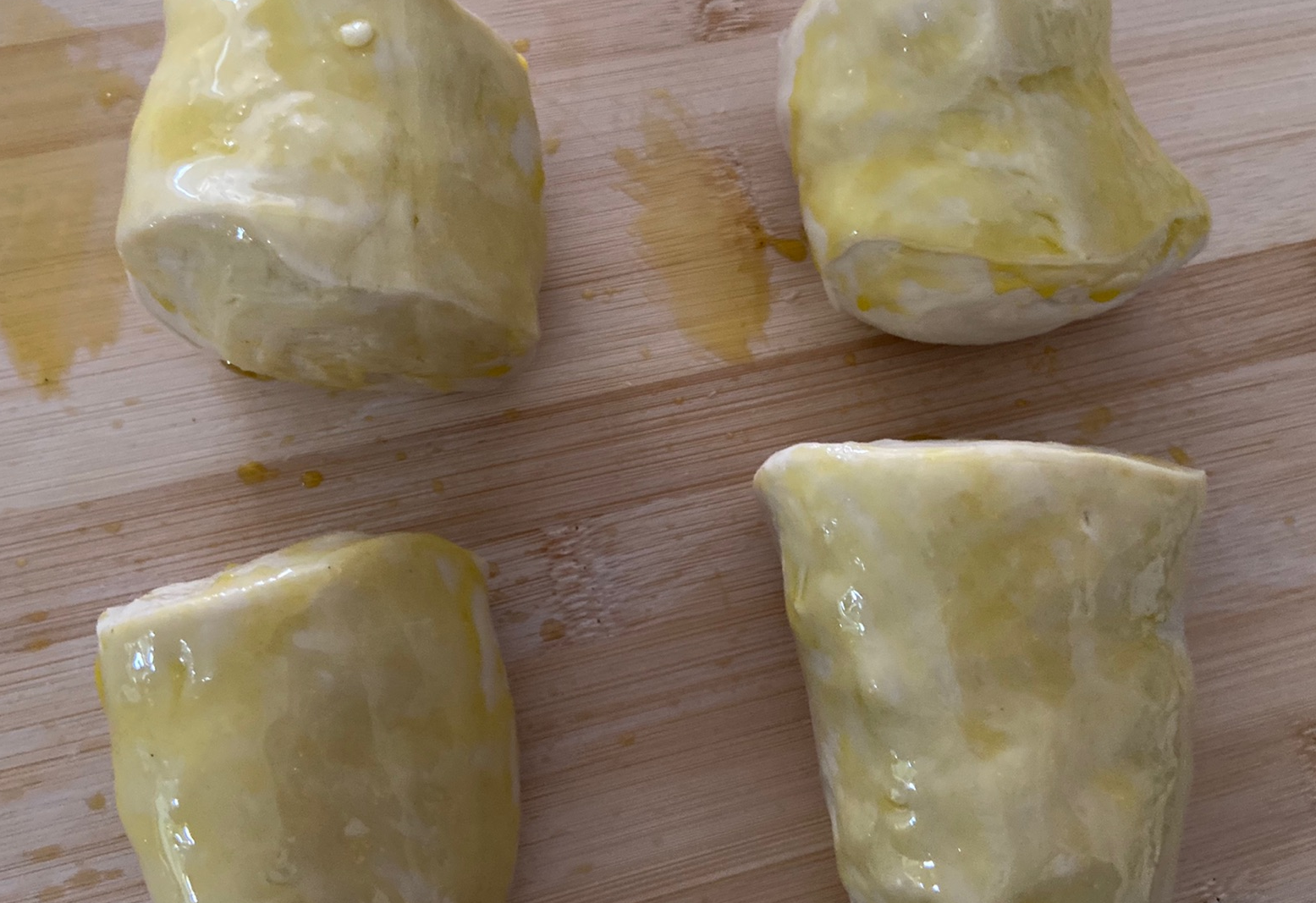 Divide dough into 4, brush with oil, cover & rest for 30 mins. Check if properly rested by poking surface.