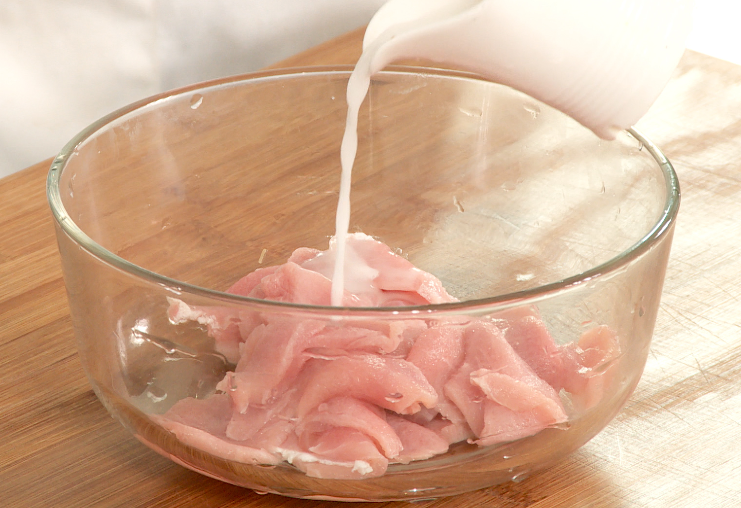 Marinate thinly sliced pork in cornstarch slurry for 10 minutes.