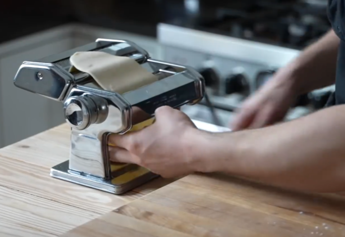 Roll out pasta dough on thickest setting of machine to create thin sheet.