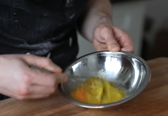 Scramble the egg using a whisk or mixer to create egg mixture.