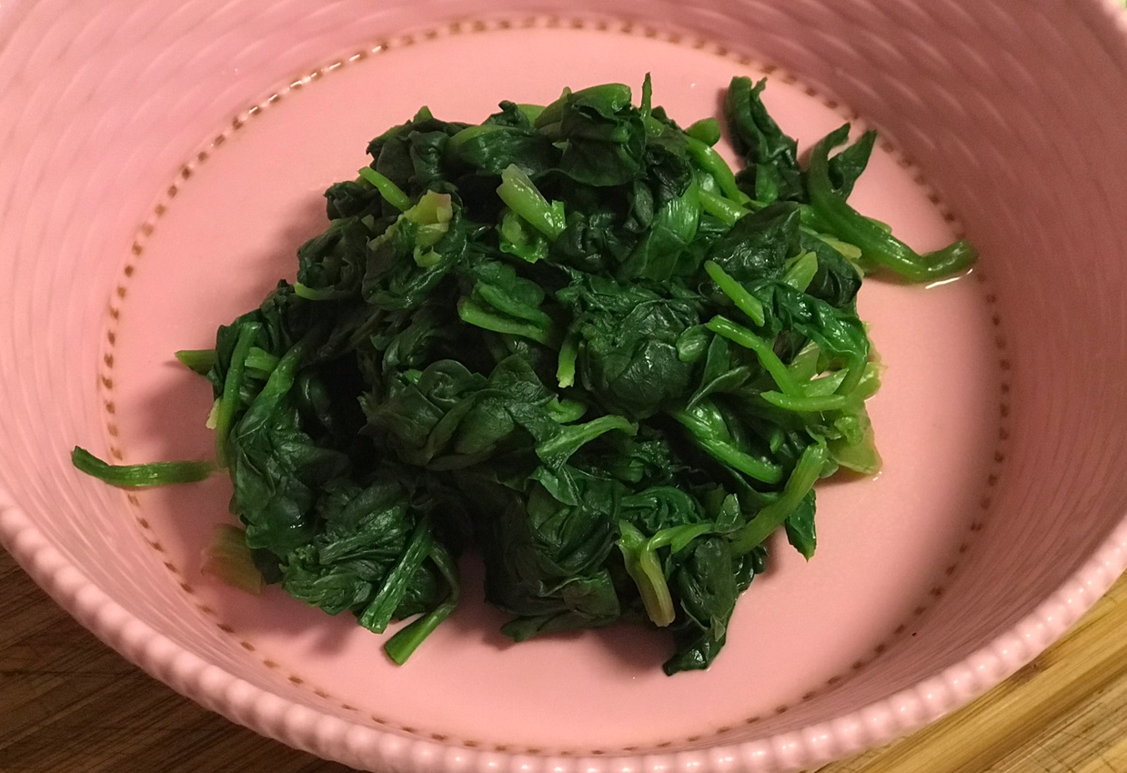 Blanch spinach, cool in water, drain excess, then chop.