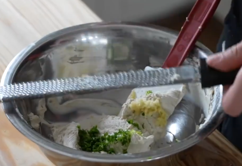 Chop scallions and garlic into minced pieces, then add to mixture and stir.