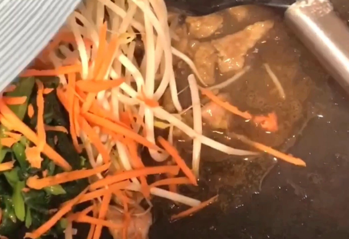 Stir-fry mixed vegetables (carrot, sprouts, spinach) until evenly coated.