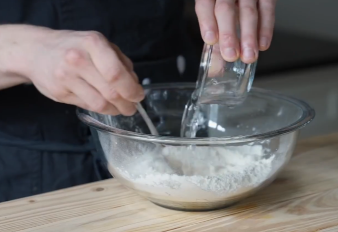 Stir flour with hot water and oil using a fork to form a dough ball.