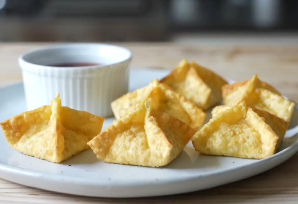 Serve crab rangoons with sweet and spicy sauce.