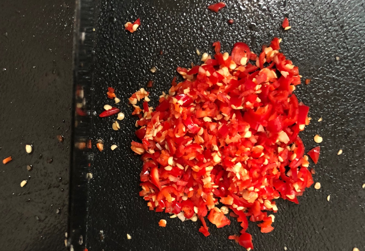 Chop 400g bird's eye chilies, blend with 400g garlic in processor for efficiency.