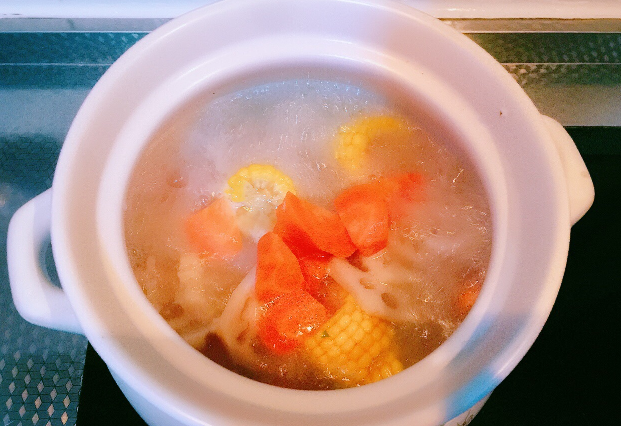 Add lotus root, corn, and carrots to pot, bring to boil over high heat.