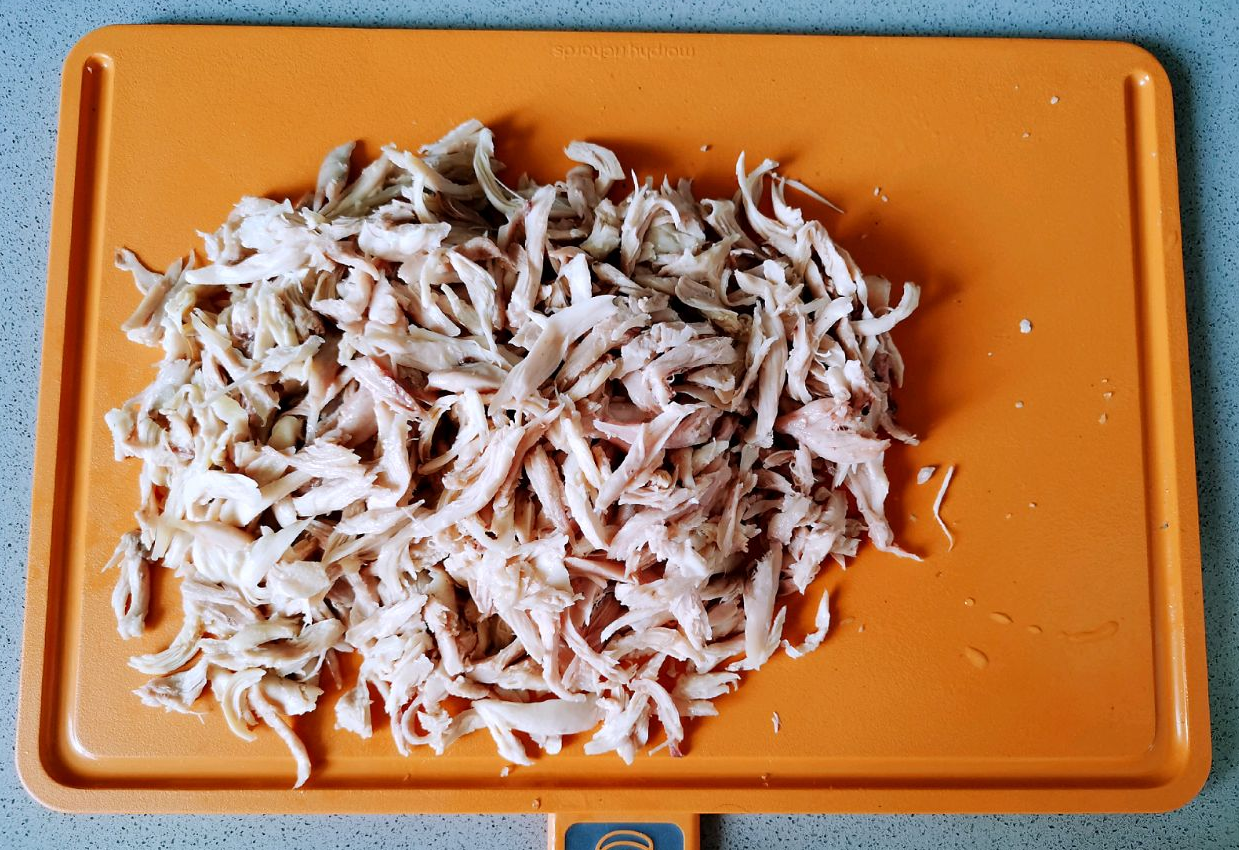 Shred chicken meat by hand after removing bones.