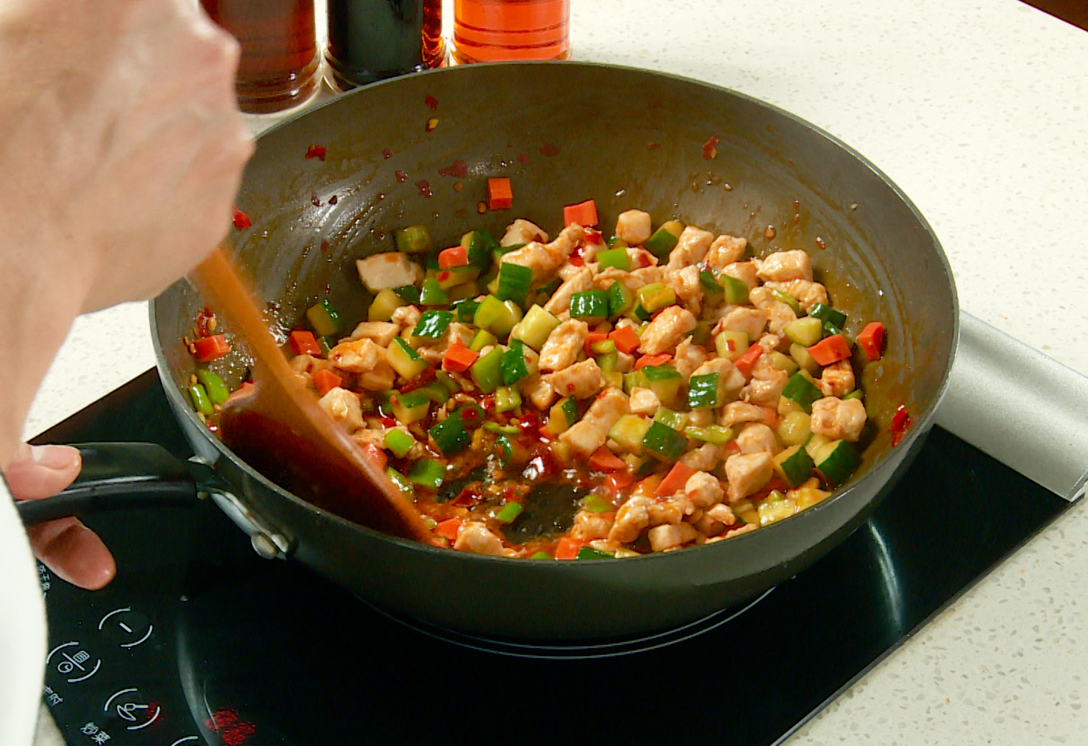 Combine diced vegetables and cooked chicken, stir-fry, then thicken with cornstarch mixture.