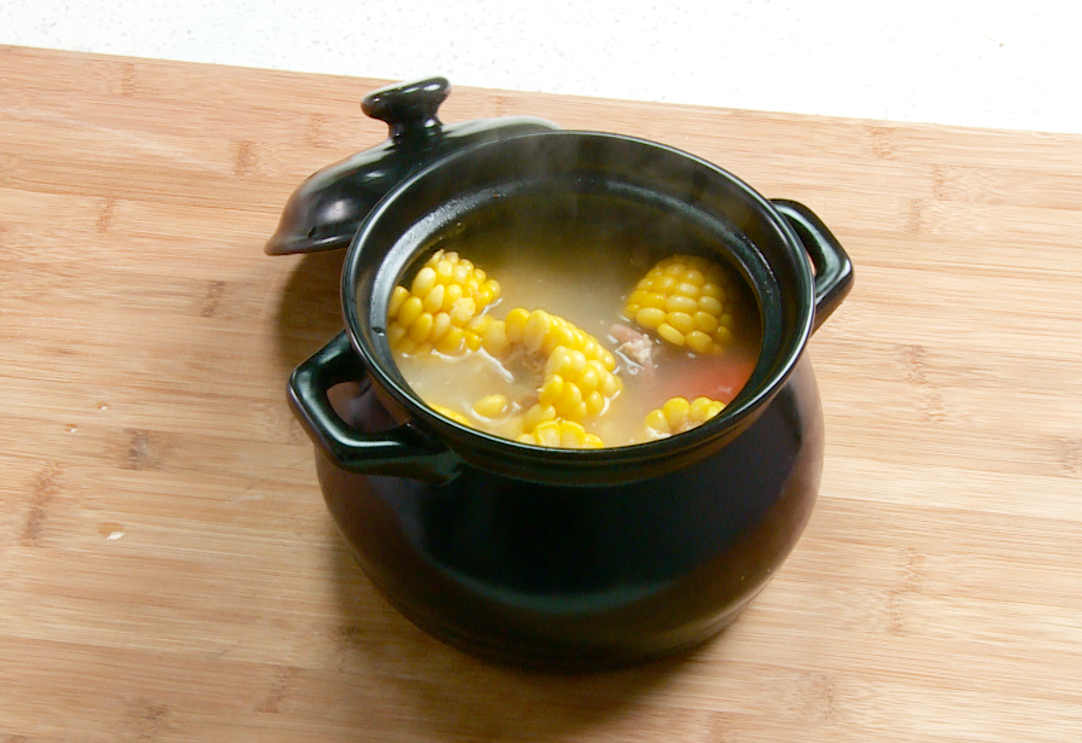 Season soup with salt after 1.5 hours, serve hot with garnished green onions.